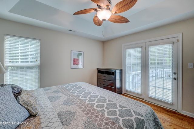 1414 Kellum Ct, Wilmington, NC 28412 - bedroom featuring access to exterior, multiple windows, wood finished floors, and ceiling fan