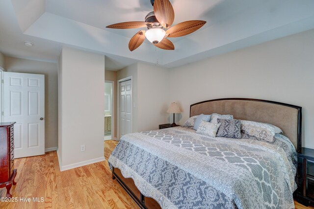 1414 Kellum Ct, Wilmington, NC 28412 - bedroom featuring a raised ceiling, wood finished floors, a closet, baseboards, and ceiling fan