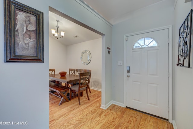 1414 Kellum Ct, Wilmington, NC 28412 - entrance foyer with light wood-type flooring, a chandelier, and baseboards