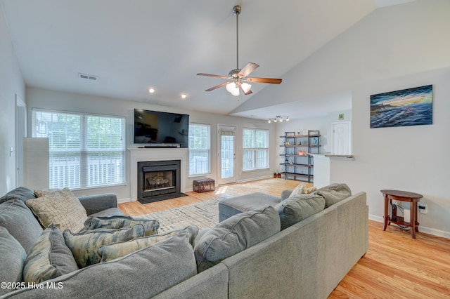 1414 Kellum Ct, Wilmington, NC 28412 - living area featuring lofted ceiling, a ceiling fan, light wood-style floors, baseboards, and a fireplace with flush hearth