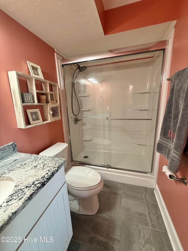 2000 New River Inlet Rd Unit 2602, North Topsail Beach, NC 28460 - full bath featuring toilet, vanity, a textured ceiling, and a shower stall