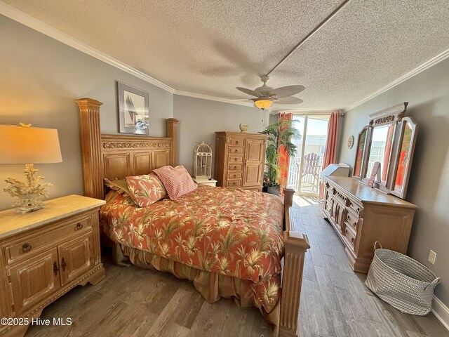 2000 New River Inlet Rd Unit 2602, North Topsail Beach, NC 28460 - bedroom with access to exterior, crown molding, a ceiling fan, a textured ceiling, and dark wood-type flooring