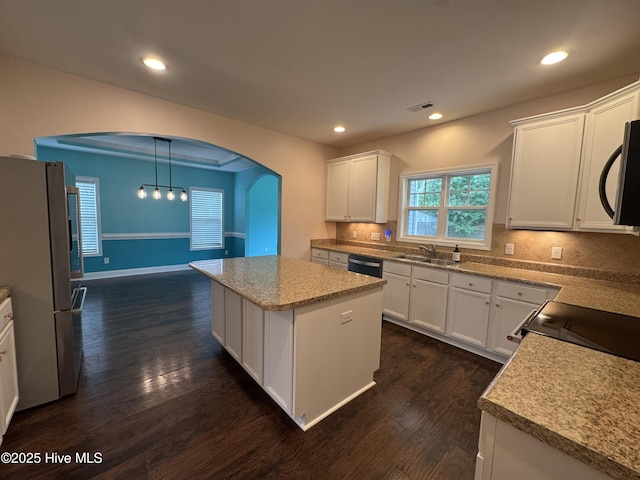 427 Wolfe Ln, Hubert, NC 28539 - kitchen with freestanding refrigerator, arched walkways, stainless steel microwave, dark wood-type flooring, and recessed lighting
