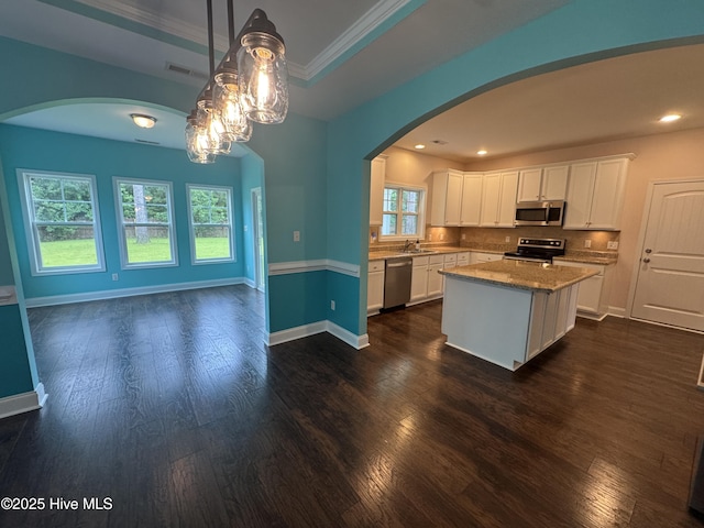 427 Wolfe Ln, Hubert, NC 28539 - kitchen featuring appliances with stainless steel finishes, arched walkways, white cabinets, dark wood-style flooring, and crown molding