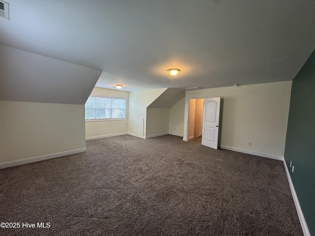 427 Wolfe Ln, Hubert, NC 28539 - additional living space with dark colored carpet and lofted ceiling