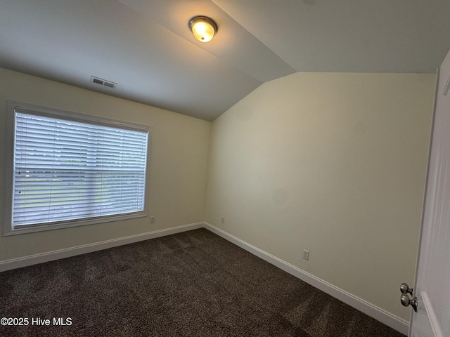 427 Wolfe Ln, Hubert, NC 28539 - empty room with vaulted ceiling and dark colored carpet