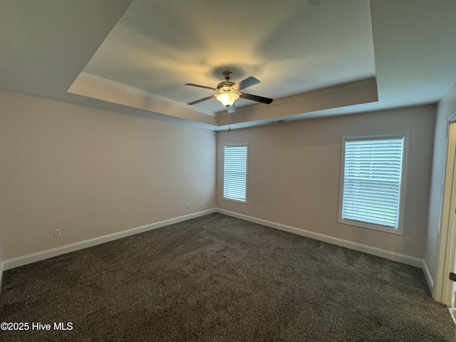 427 Wolfe Ln, Hubert, NC 28539 - unfurnished room featuring a tray ceiling, ornamental molding, dark colored carpet, and a ceiling fan