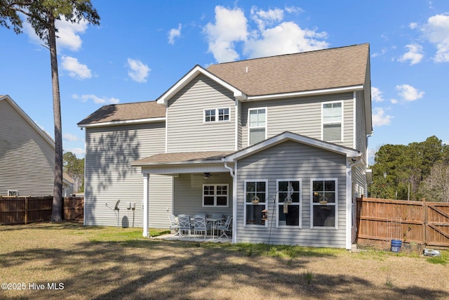 427 Wolfe Ln, Hubert, NC 28539 - rear view of house with ceiling fan, a fenced backyard, a patio, and a shingled roof