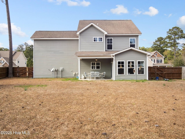 427 Wolfe Ln, Hubert, NC 28539 - rear view of house featuring a fenced backyard, a gate, a patio area, and roof with shingles