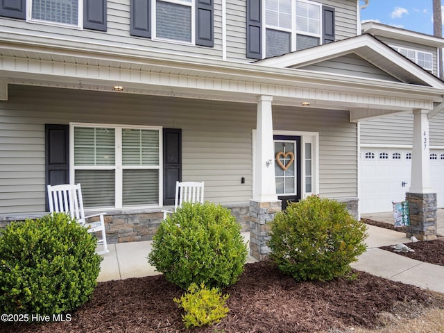 427 Wolfe Ln, Hubert, NC 28539 - doorway to property with covered porch and stone siding