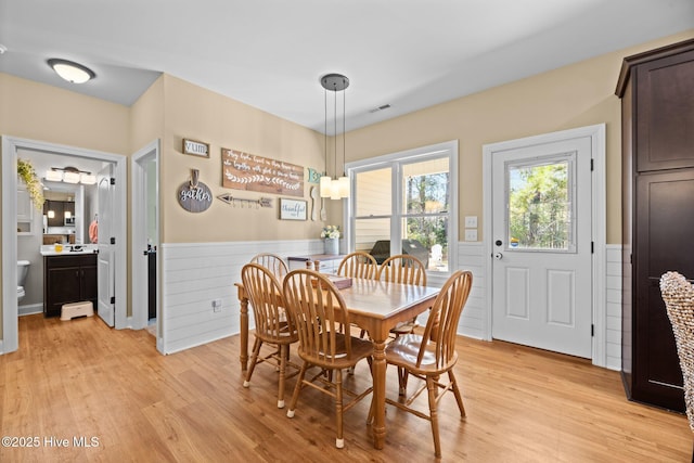 214 Green Trees Dr, New Bern, NC 28560 - dining space with visible vents, light wood finished floors, and a wainscoted wall