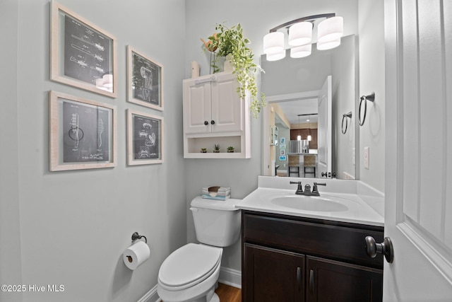 214 Green Trees Dr, New Bern, NC 28560 - bathroom with vanity, baseboards, wood finished floors, and toilet
