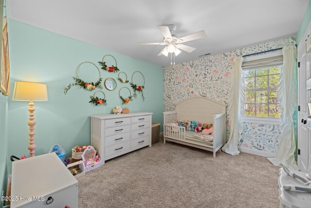 214 Green Trees Dr, New Bern, NC 28560 - carpeted bedroom featuring a crib, a ceiling fan, and wallpapered walls