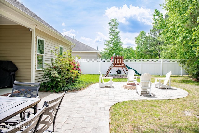 214 Green Trees Dr, New Bern, NC 28560 - view of patio featuring a fenced backyard, outdoor dining area, a grill, a playground, and a fire pit