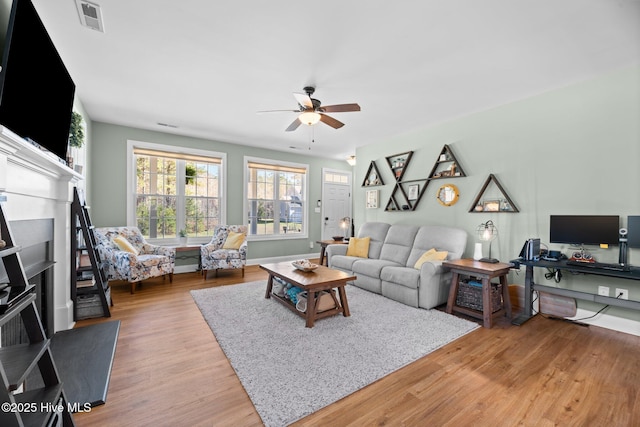 214 Green Trees Dr, New Bern, NC 28560 - living room featuring visible vents, baseboards, ceiling fan, and light wood-type flooring