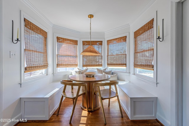 dining area with crown molding, dark wood-style floors, and breakfast area