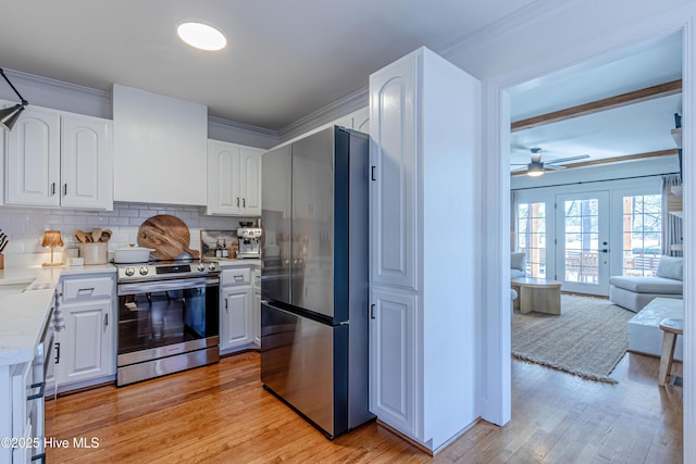kitchen with white cabinetry, crown molding, light wood-type flooring, and appliances with stainless steel finishes
