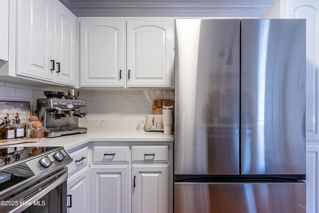 kitchen with white cabinetry, backsplash, and stainless steel appliances