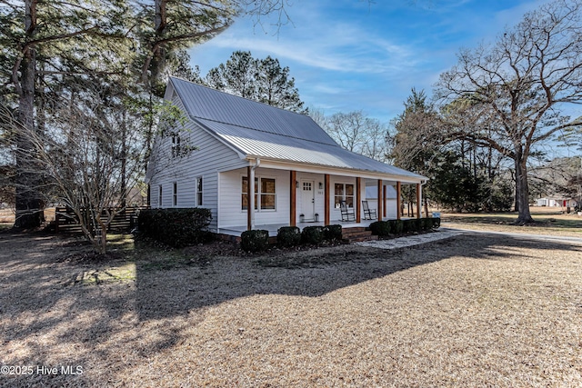 view of front of property featuring covered porch and metal roof