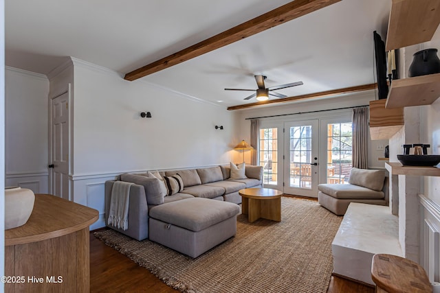 living area with beamed ceiling, wood finished floors, ceiling fan, and crown molding