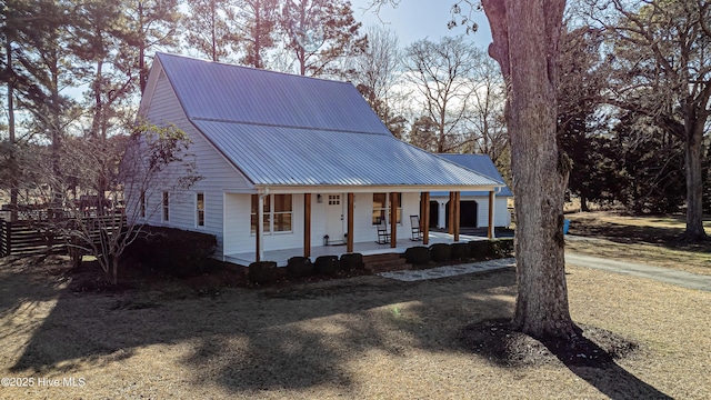 view of front of house with a porch and metal roof