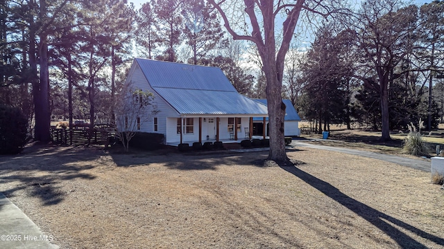 view of front of house featuring covered porch and metal roof