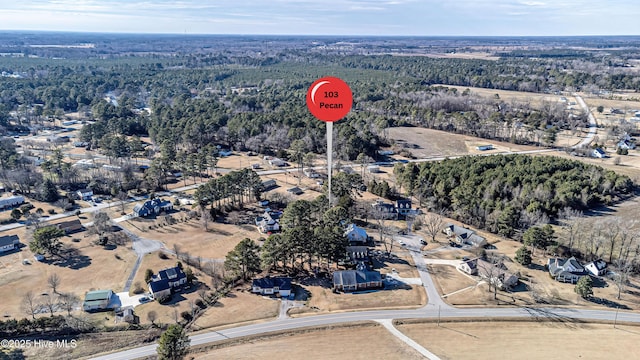 drone / aerial view with a wooded view