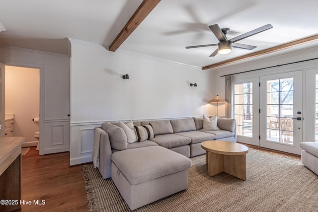 living room with beam ceiling, crown molding, ceiling fan, and wood finished floors