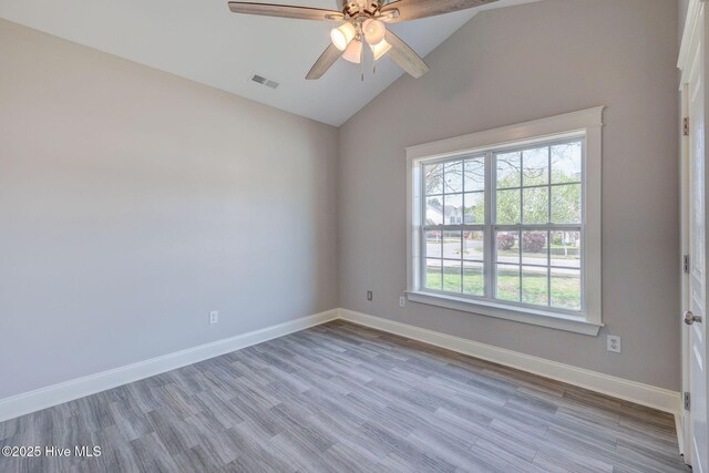 unfurnished room with high vaulted ceiling, wood finished floors, ceiling fan, baseboards, and visible vents