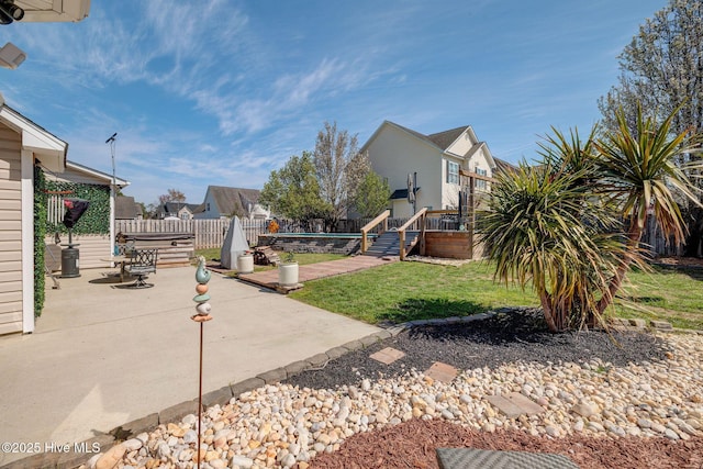 view of yard featuring a fenced backyard, a residential view, and a patio area