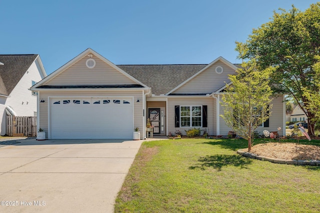 view of front of home with fence, a shingled roof, an attached garage, driveway, and a front yard