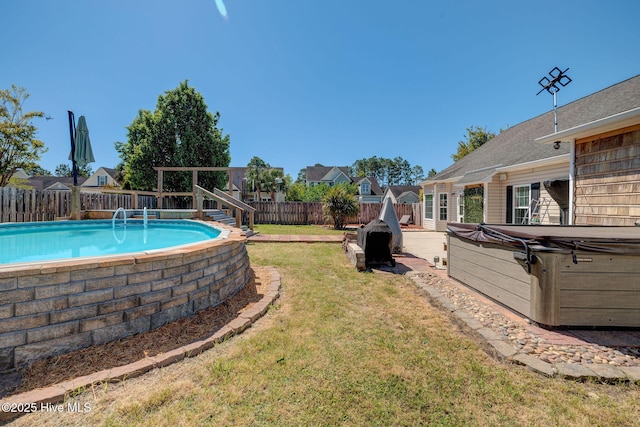 view of yard featuring a fenced in pool, a hot tub, and a fenced backyard