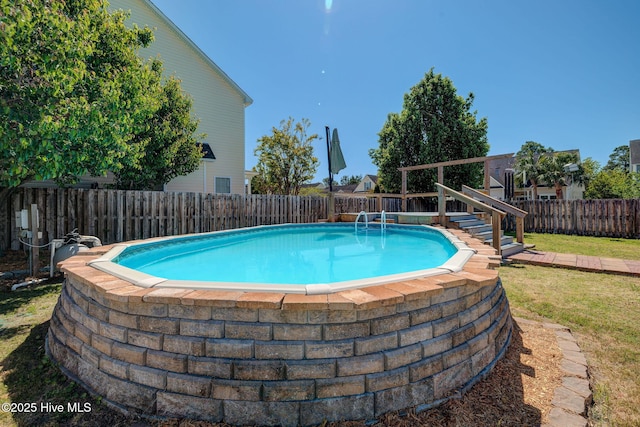 view of pool with a yard, a fenced in pool, and a fenced backyard