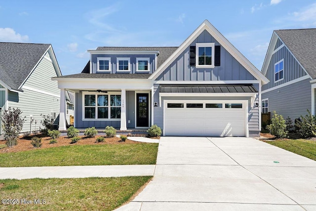 1348 Trisail Ter, Wilmington, NC 28412 - view of front of house with driveway, covered porch, a shingled roof, board and batten siding, and a front yard