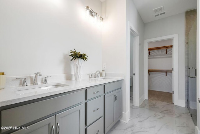 1348 Trisail Ter, Wilmington, NC 28412 - bathroom featuring a spacious closet, marble finish floor, a sink, and a stall shower