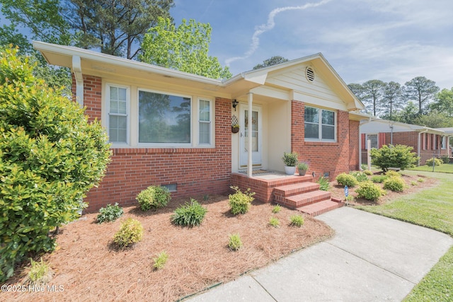 203 Mercer Rd, Jacksonville, NC 28546 - view of front facade with crawl space and brick siding