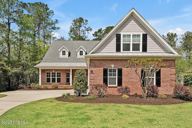 craftsman inspired home featuring a shingled roof, brick siding, and a front lawn