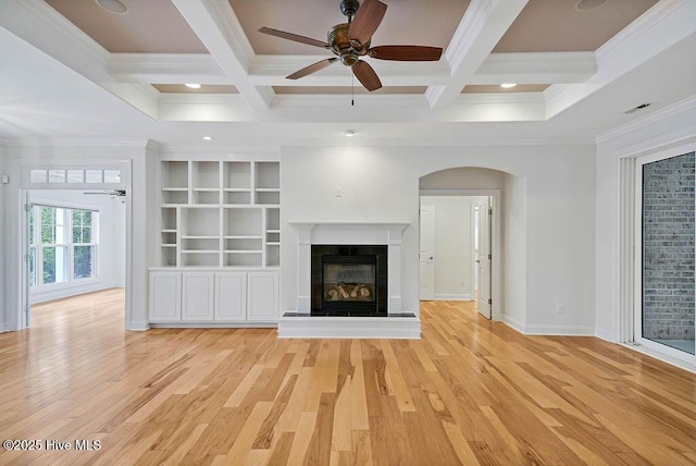 unfurnished living room with crown molding, ceiling fan, and beamed ceiling