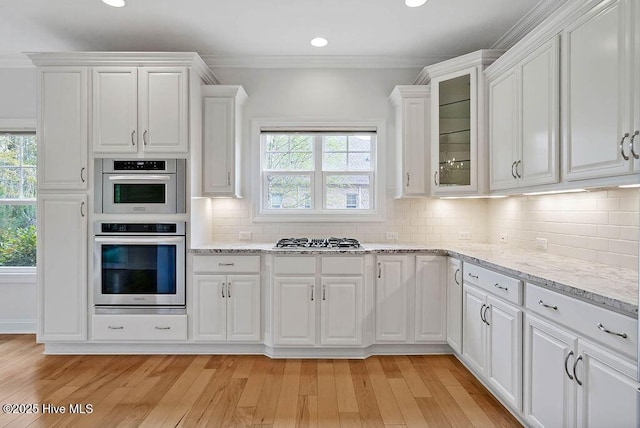 kitchen featuring white cabinets, a wealth of natural light, appliances with stainless steel finishes, and recessed lighting