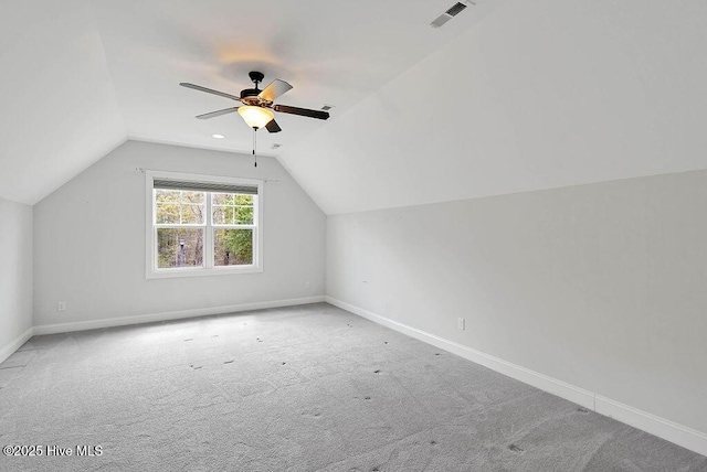 additional living space featuring visible vents, baseboards, carpet, and vaulted ceiling
