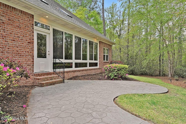 view of patio with a sunroom and entry steps