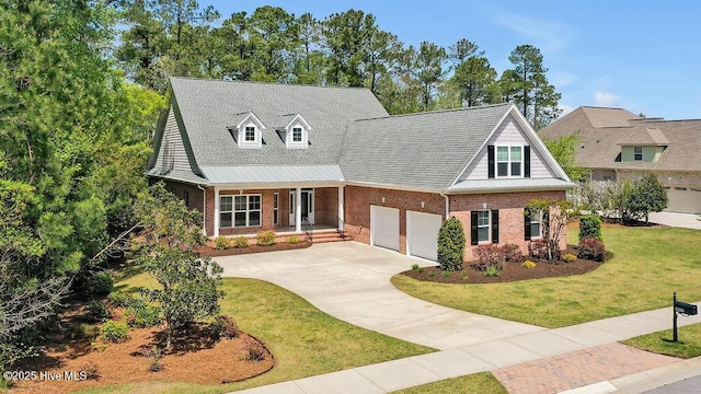 new england style home featuring concrete driveway, a front lawn, brick siding, a shingled roof, and covered porch