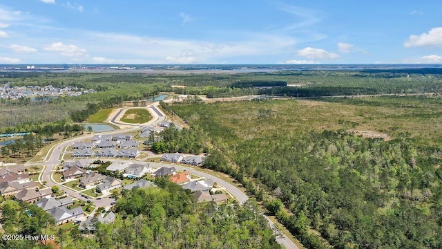 birds eye view of property featuring a view of trees and a residential view