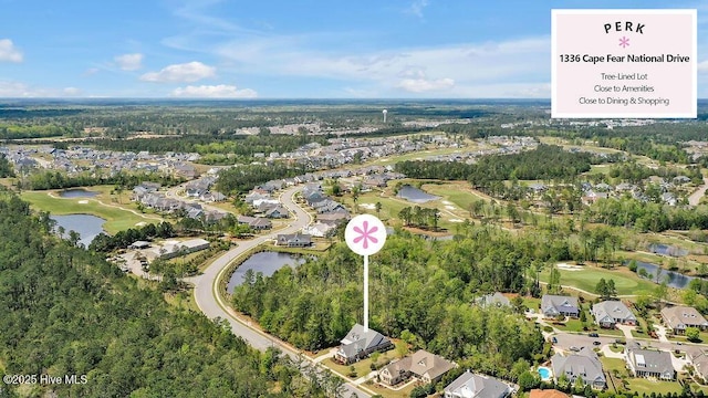 aerial view featuring a water view, view of golf course, and a residential view