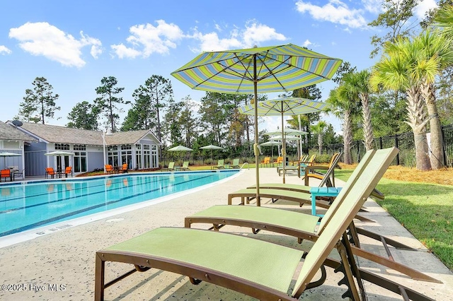 pool featuring fence and a patio