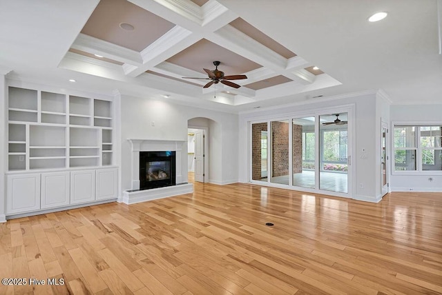 unfurnished living room with crown molding, ceiling fan, light wood-style floors, and baseboards