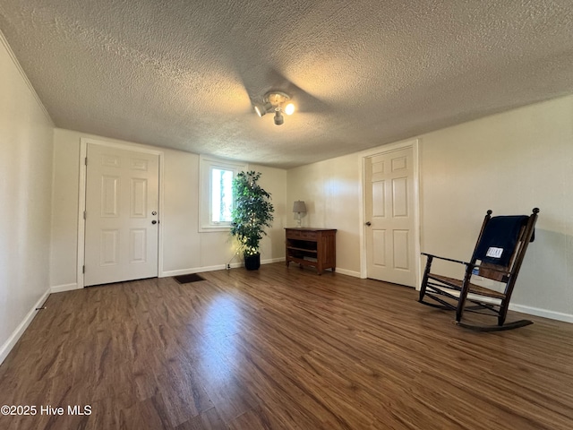 1309 Gaston Sellers Rd, Whiteville, NC 28472 - entryway with dark wood finished floors, a textured ceiling, and baseboards