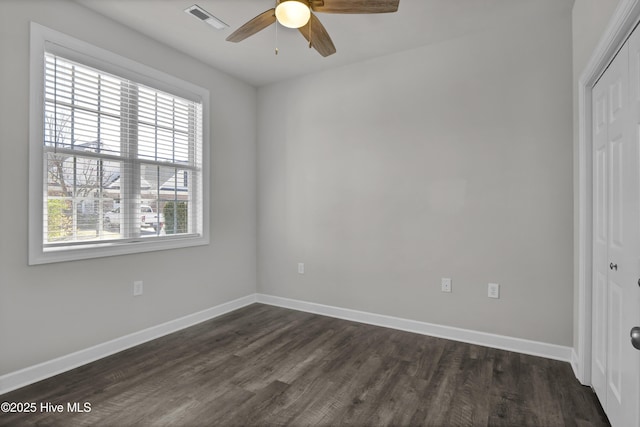 5006 Carleton Dr Unit 141, Wilmington, NC 28403 - unfurnished bedroom featuring a closet, dark wood-type flooring, baseboards, and a ceiling fan