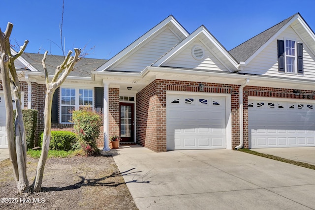 5006 Carleton Dr Unit 141, Wilmington, NC 28403 - view of front of property with brick siding, concrete driveway, a garage, and a shingled roof