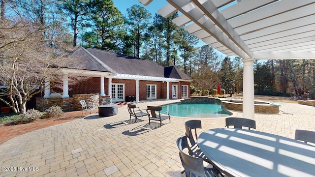 view of swimming pool with an exterior structure, french doors, an outbuilding, a pergola, and a patio